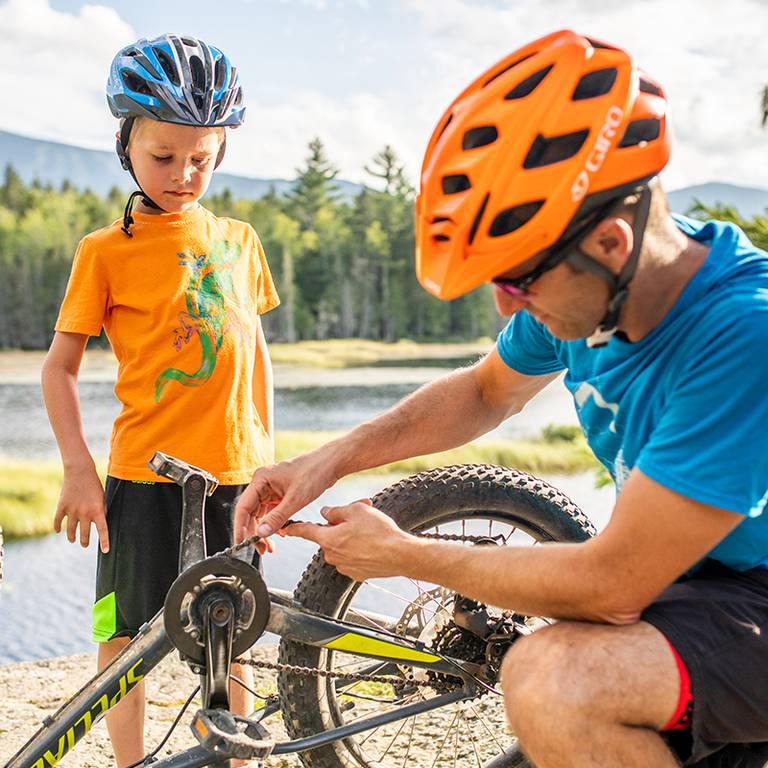 Father fixing child's bike