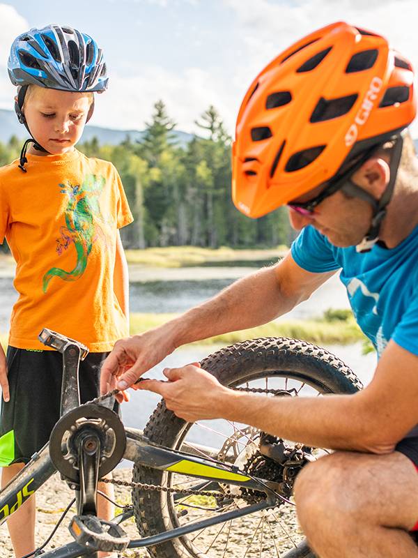 Father fixing child's bike