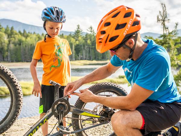 Father fixing child's bike