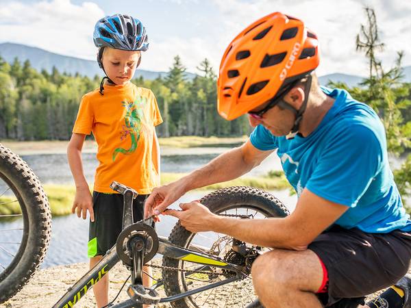 Father fixing child's bike