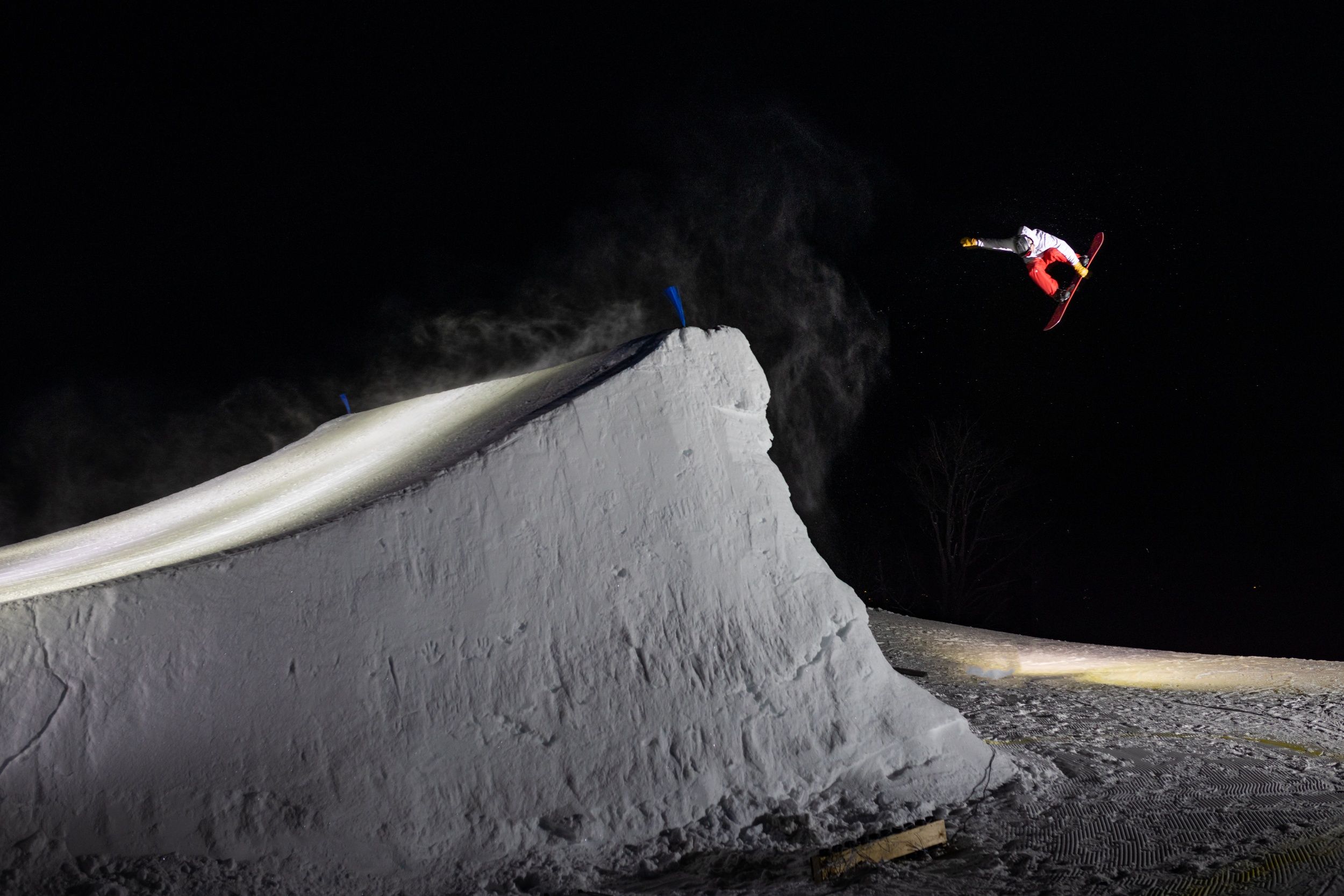 Snowboarder grabbing board in the air