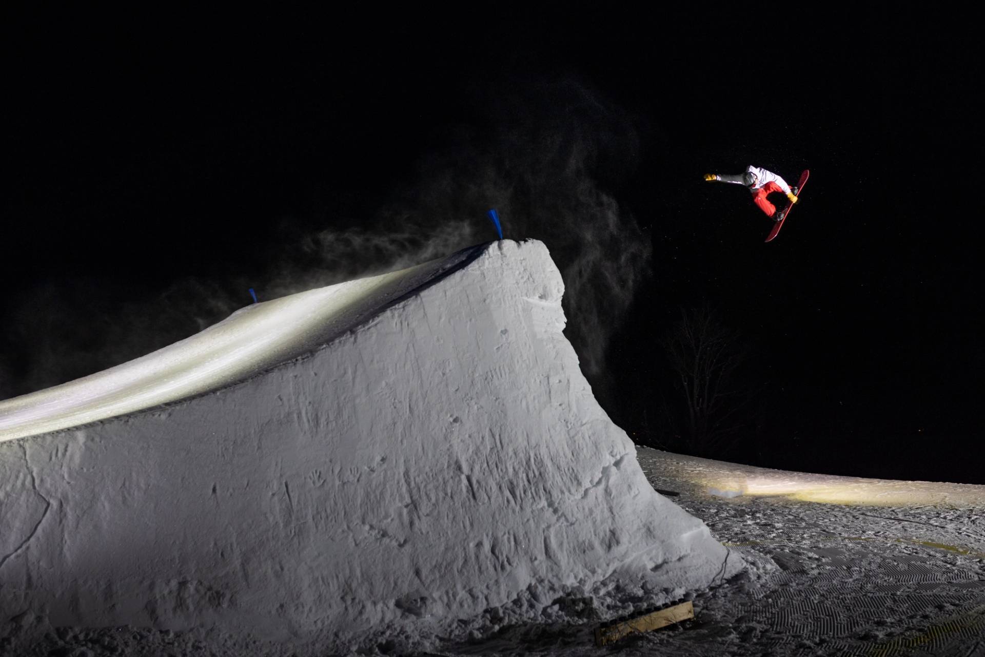 Snowboarder grabbing board in the air