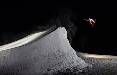 Snowboarder grabbing board in the air