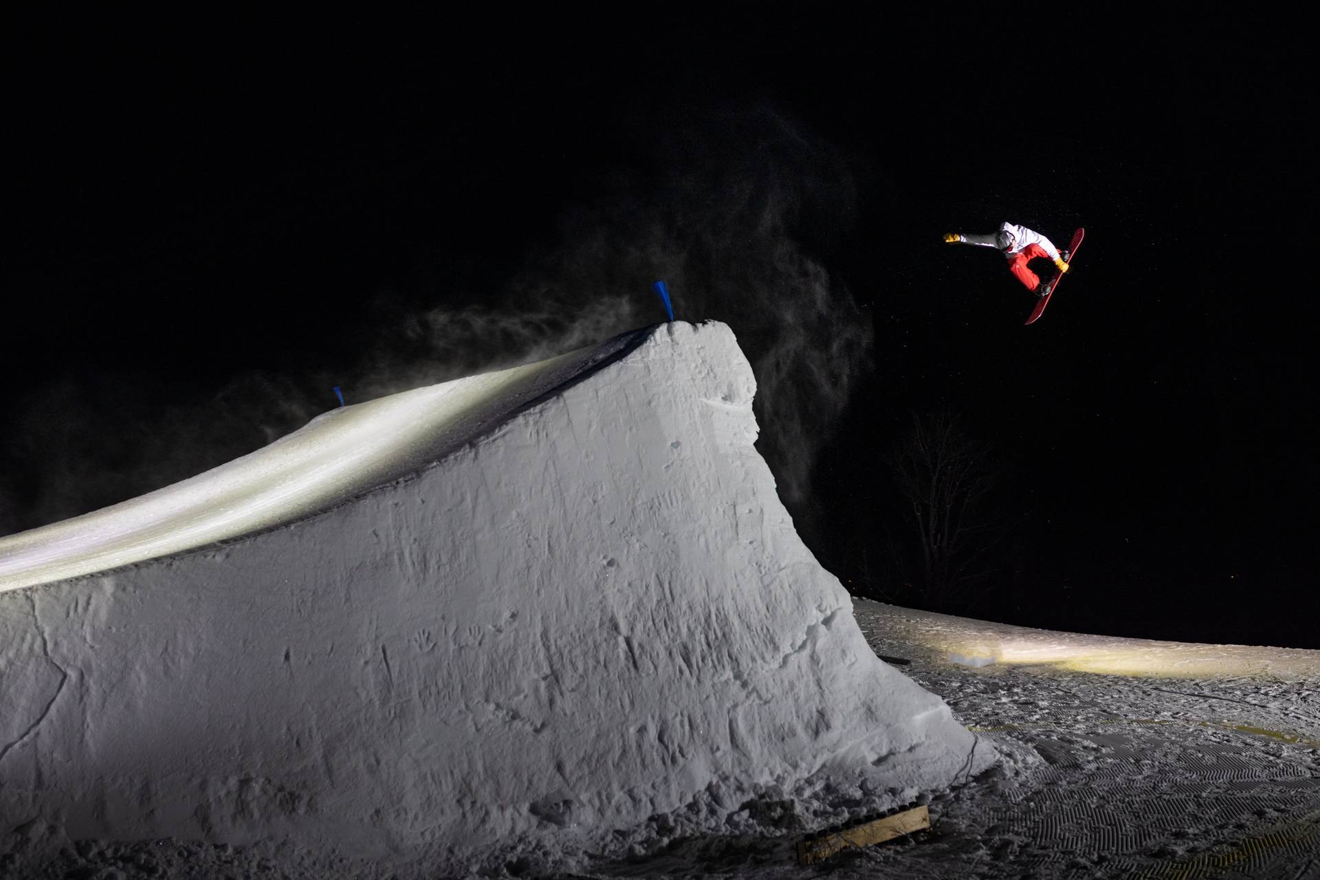 Snowboarder grabbing board in the air