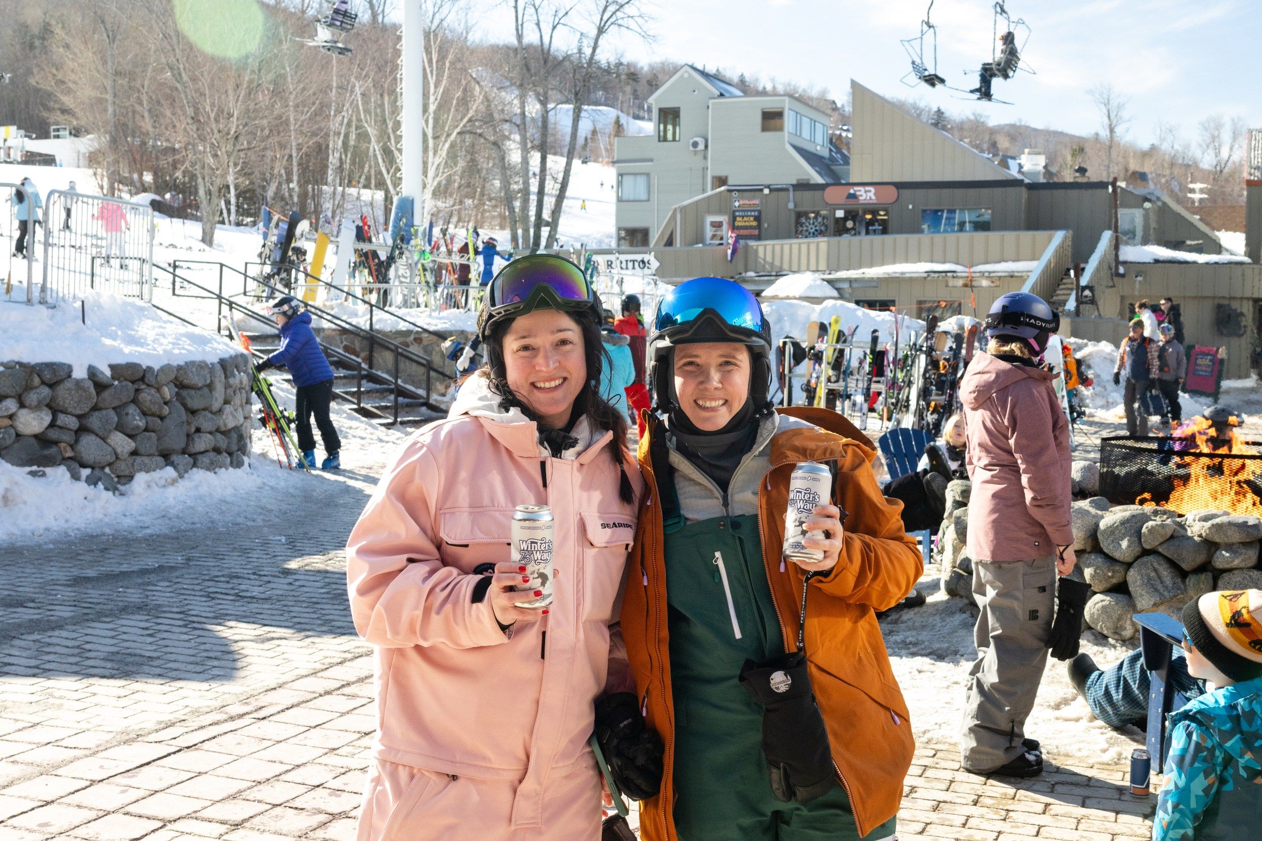 Two individuals with beverages on the beach