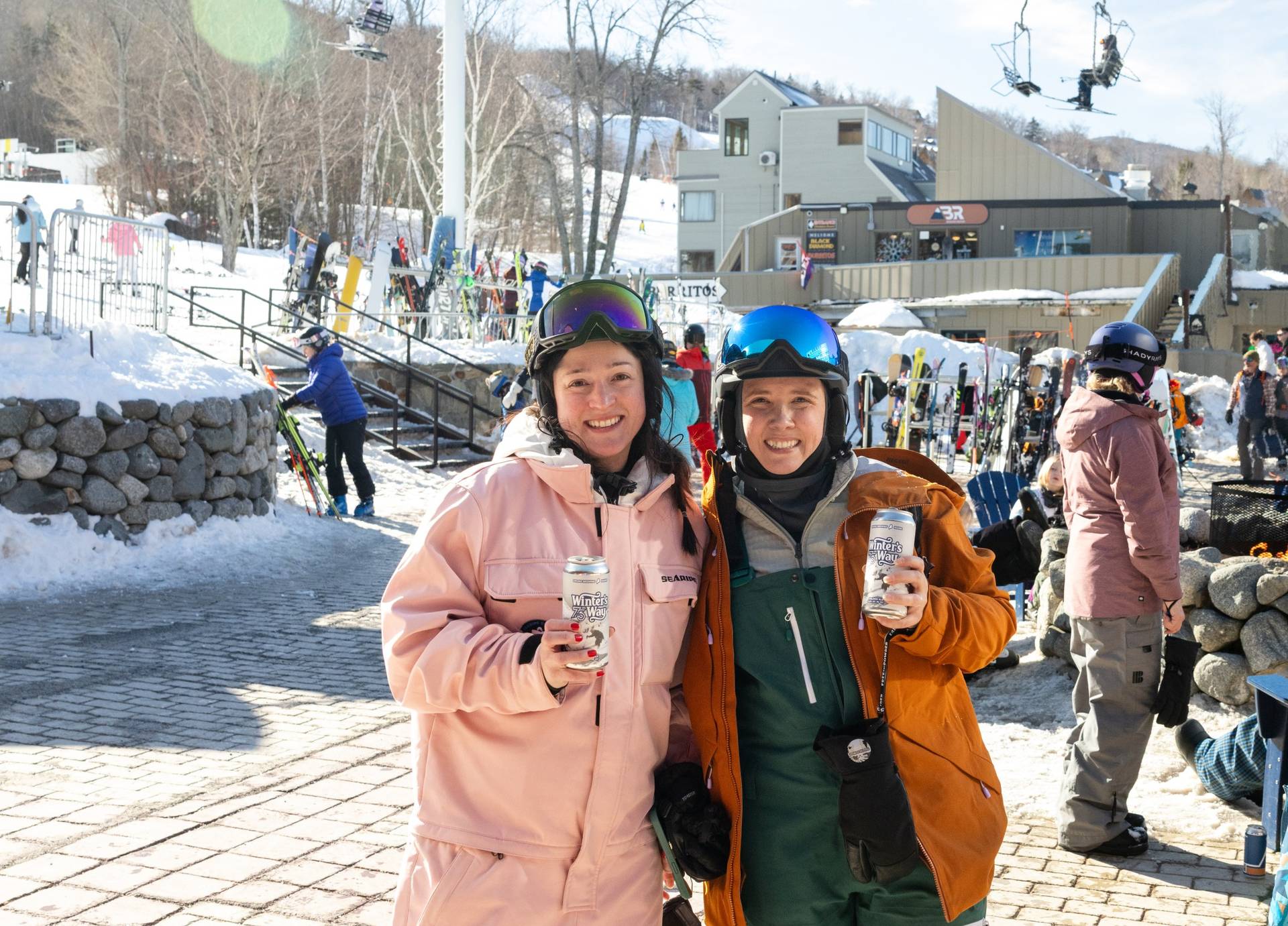 Two individuals with beverages on the beach