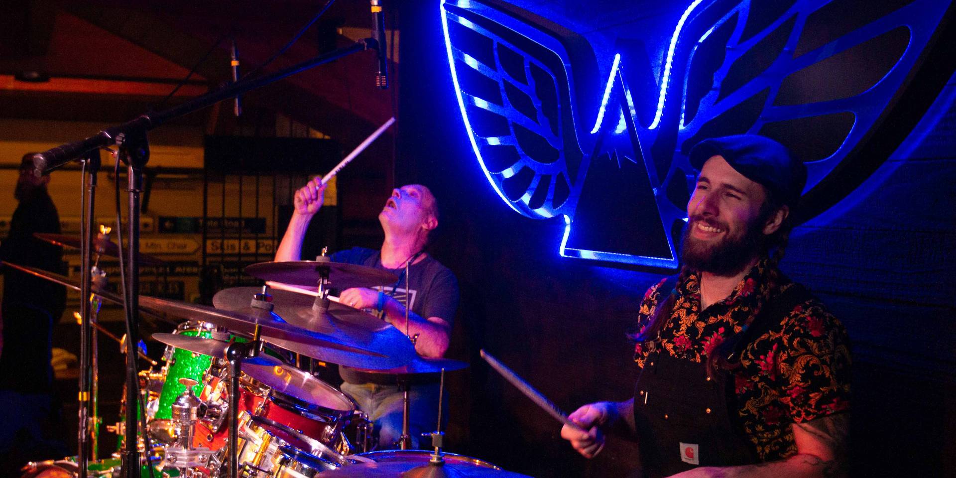 Band drumming and smiling on stage
