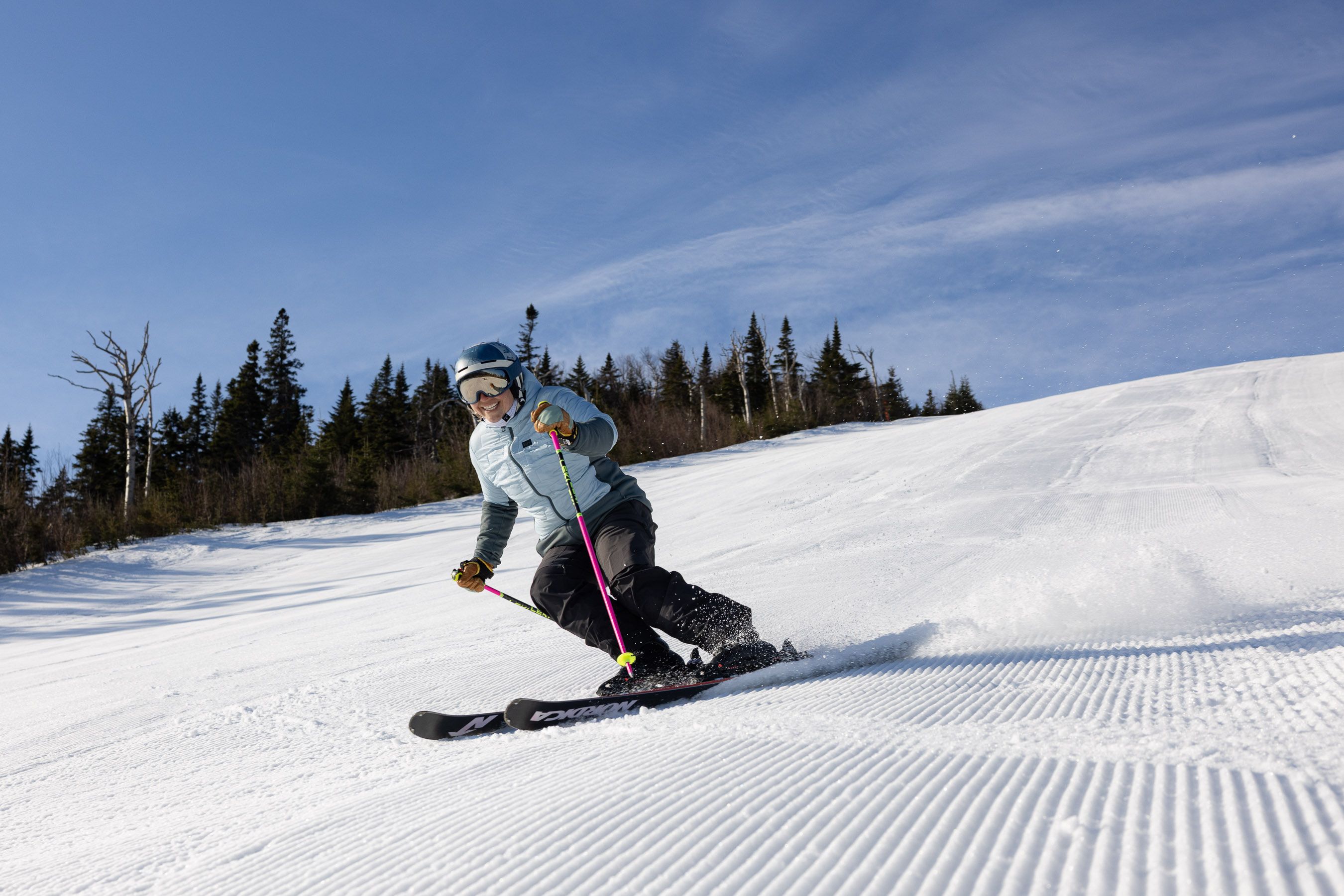 Skier and Snowboarder on groomer