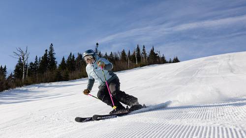 Woman skiing on groomer