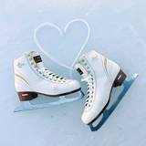 Figure skates on ice with laces shaped as a heart