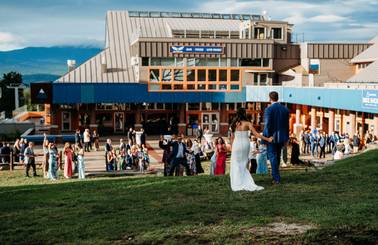 bride and groom walking to the beach