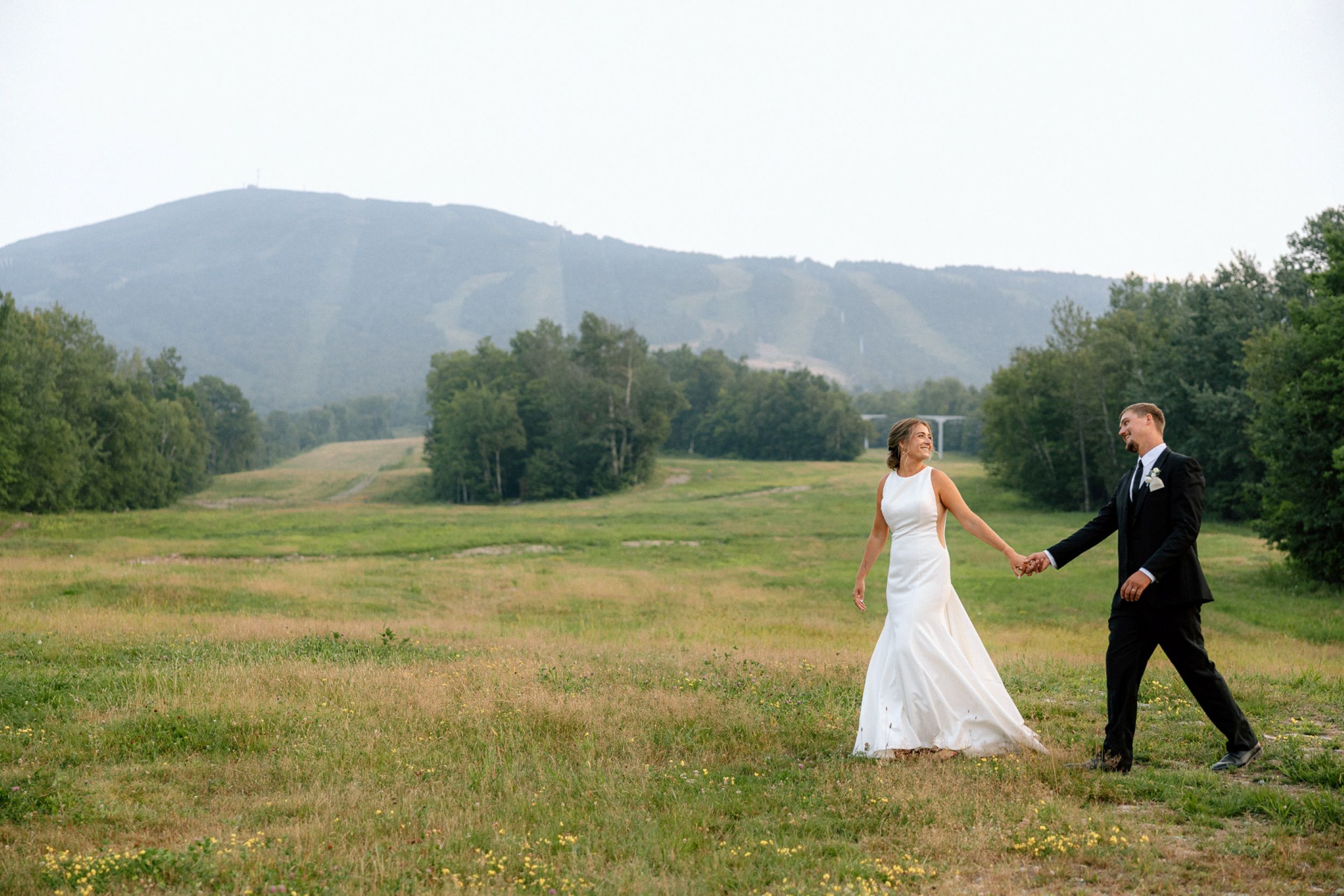 A bride and groom smiling at their wedding on The Beach 