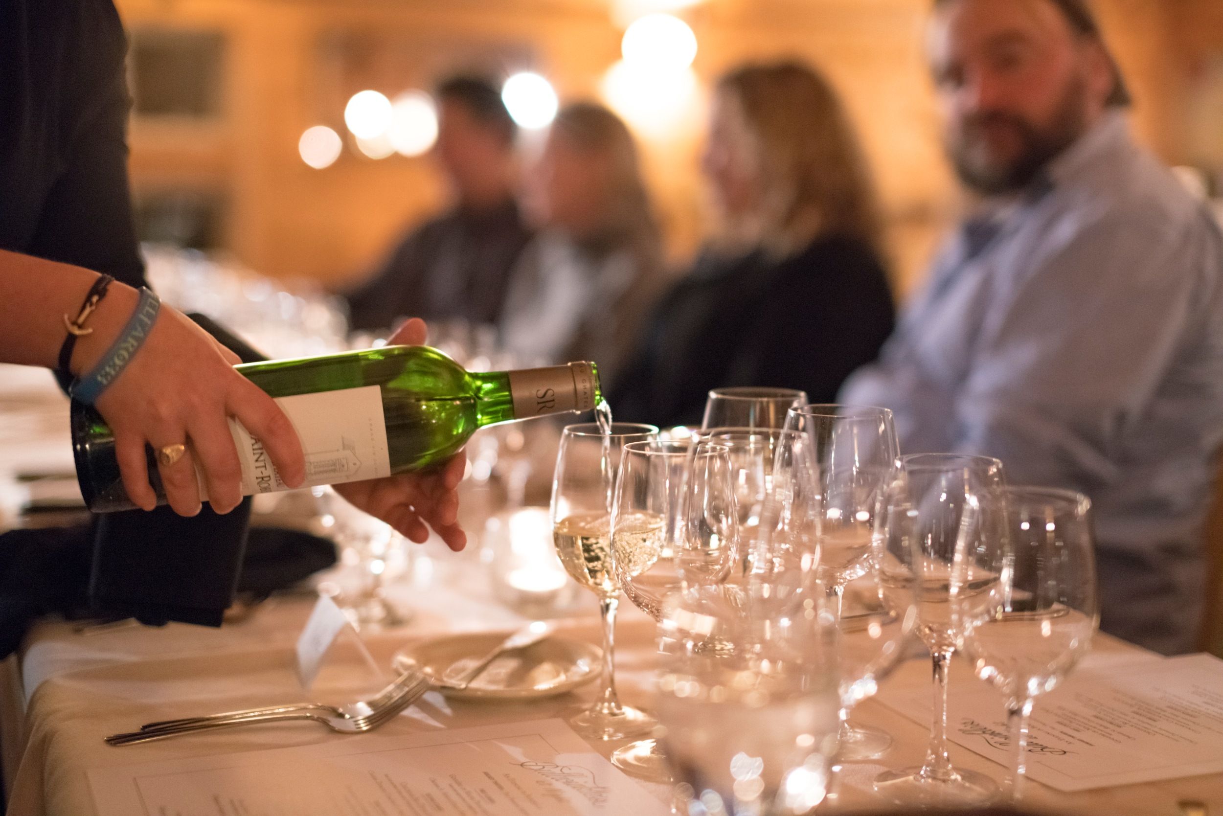 Server pouring a glass of wine