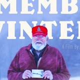 Screenshot of a man holding a photo