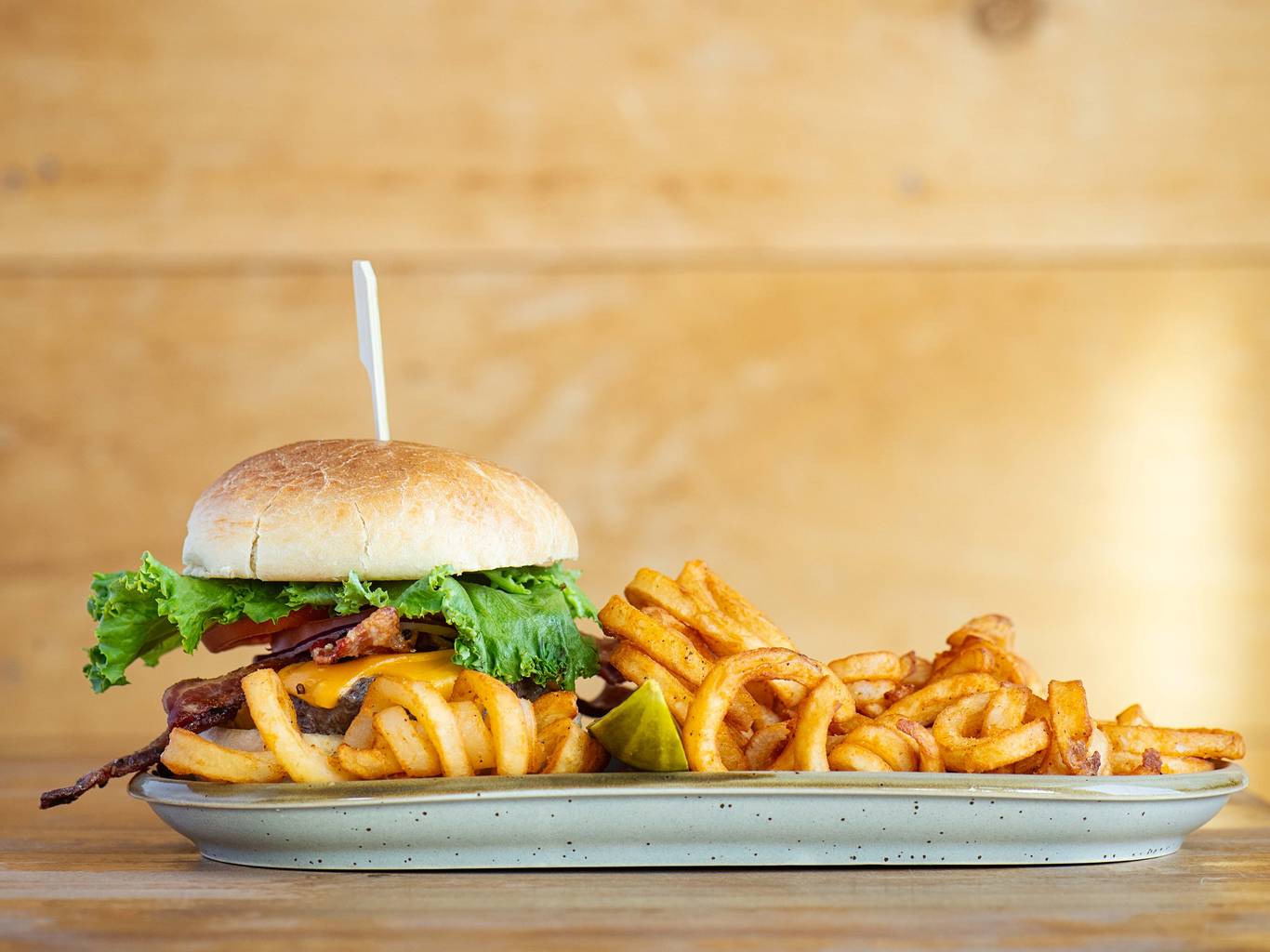 Bullwinkle's burger with a pile of the best variation of fry: curly