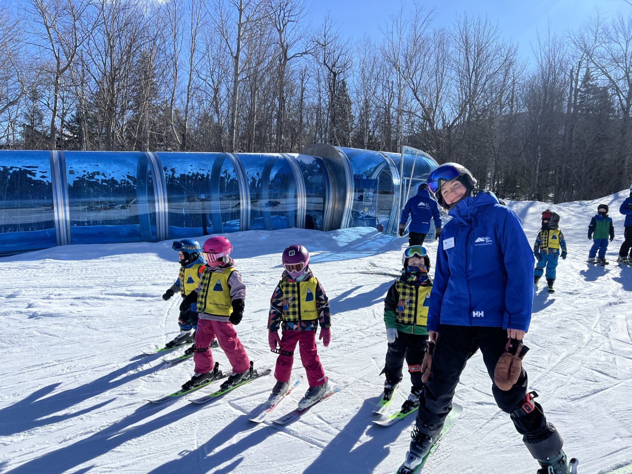 Ski instructor with young students