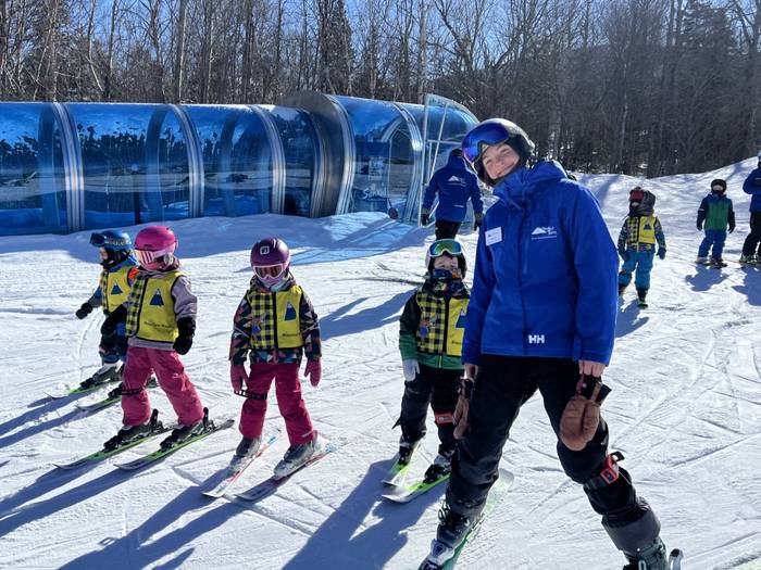 Ski instructor with young students