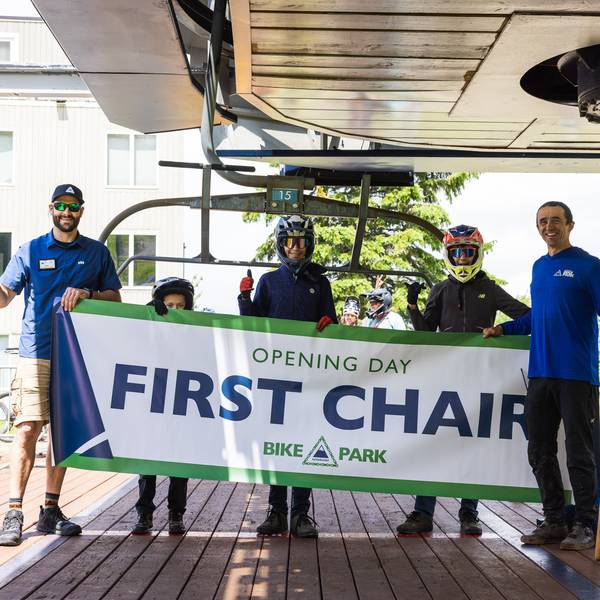 group of people holding first chair banner