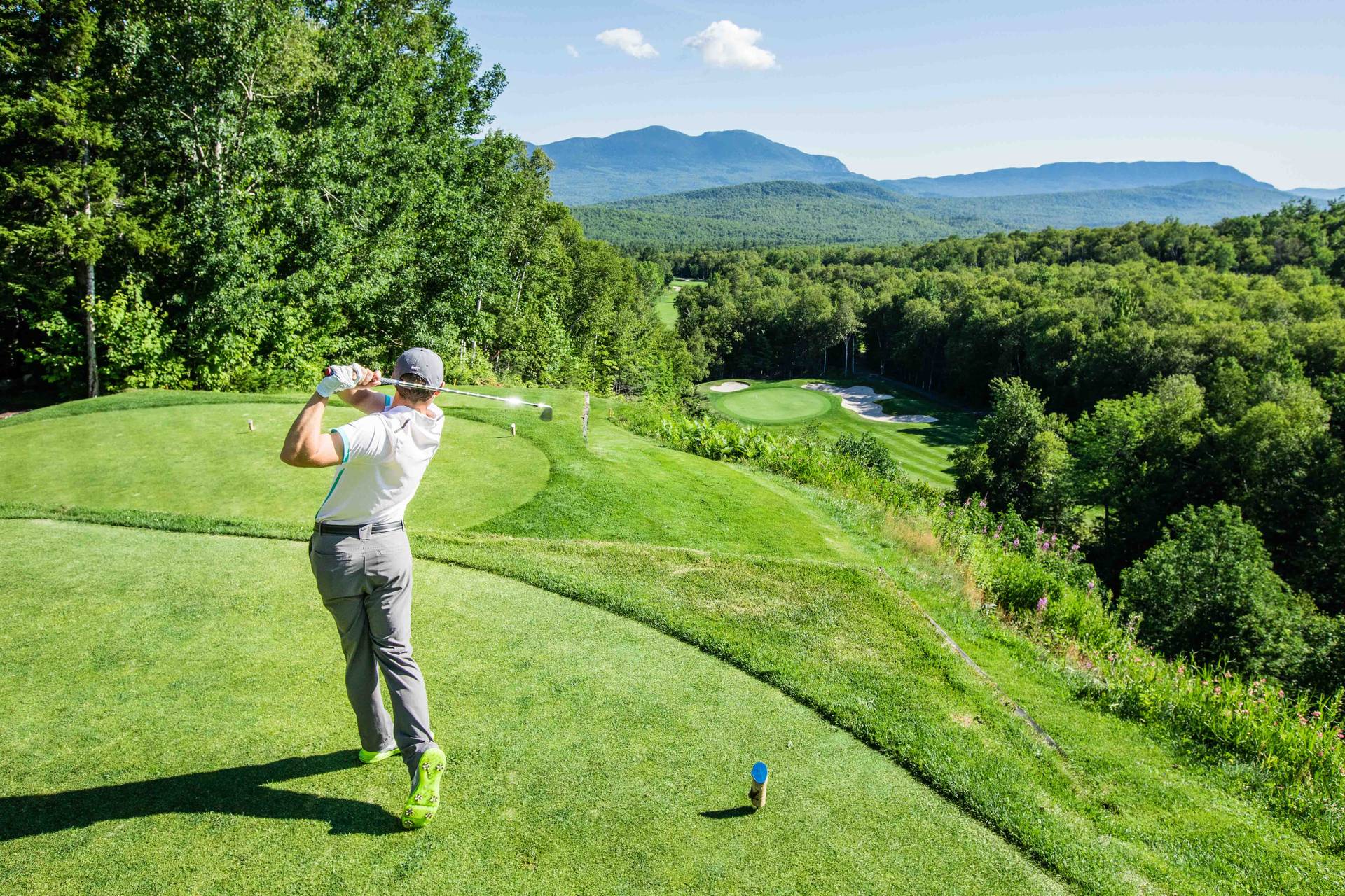 golfer teeing off
