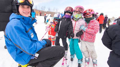 Ski instructor with students