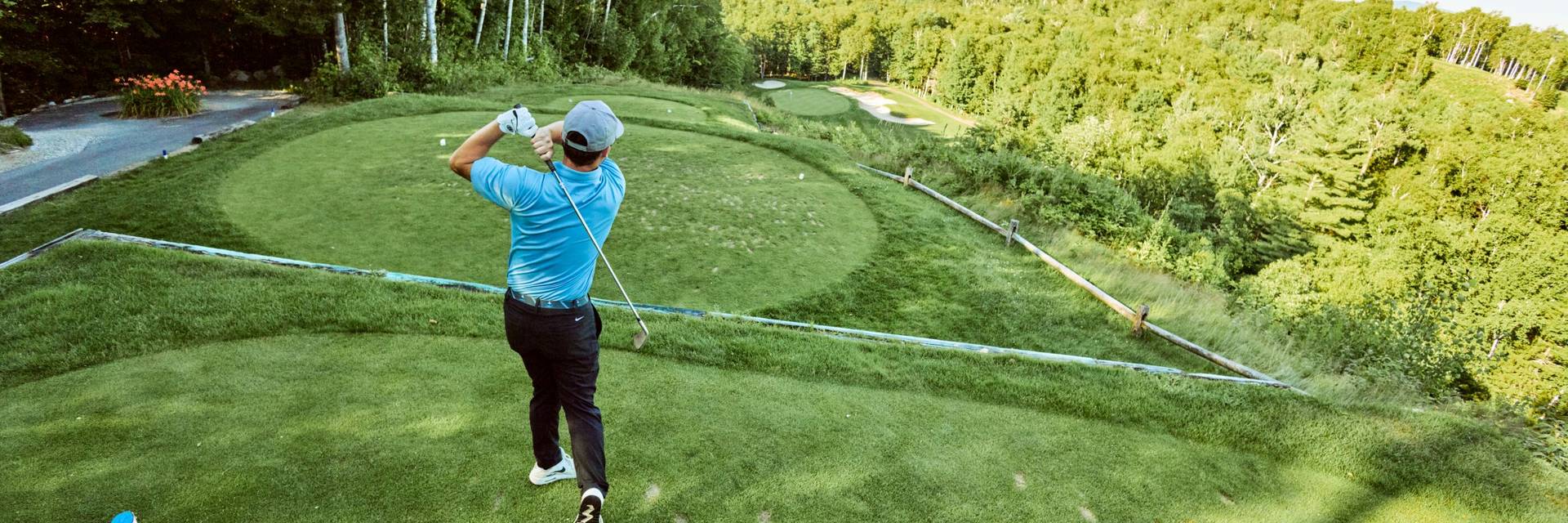 Male golfer mid swing