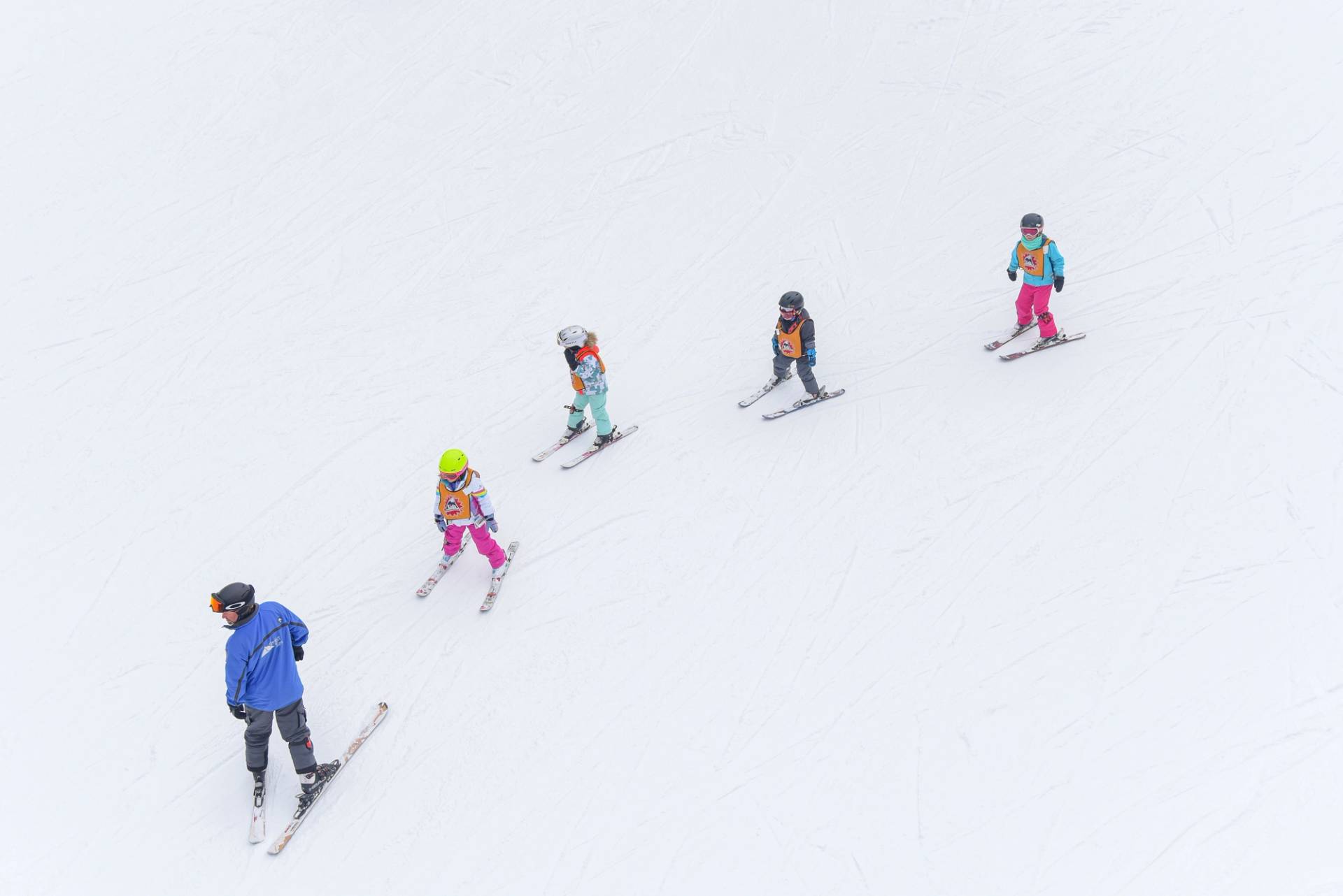 young skiers following an instructor