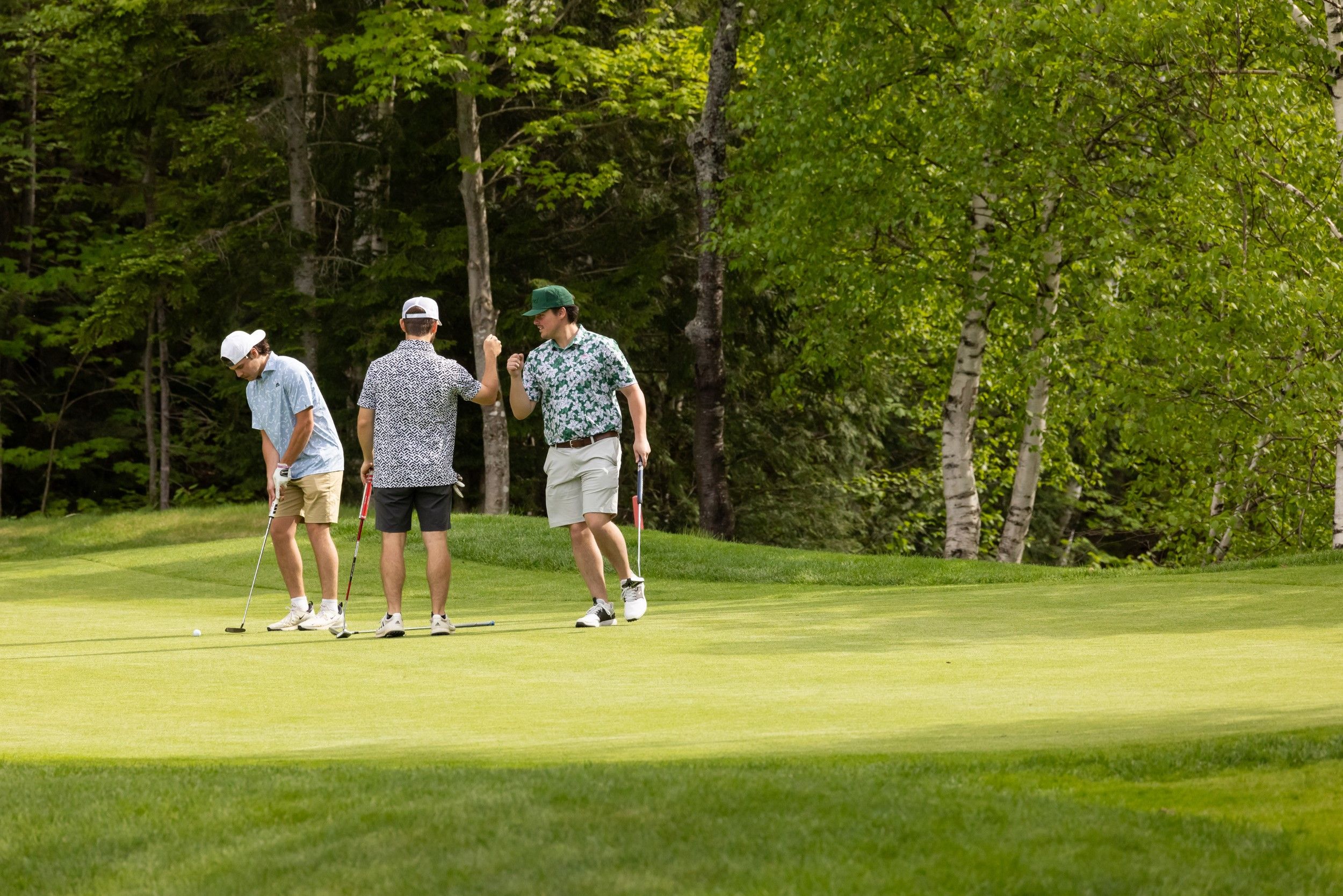 Players high-fiving on the course