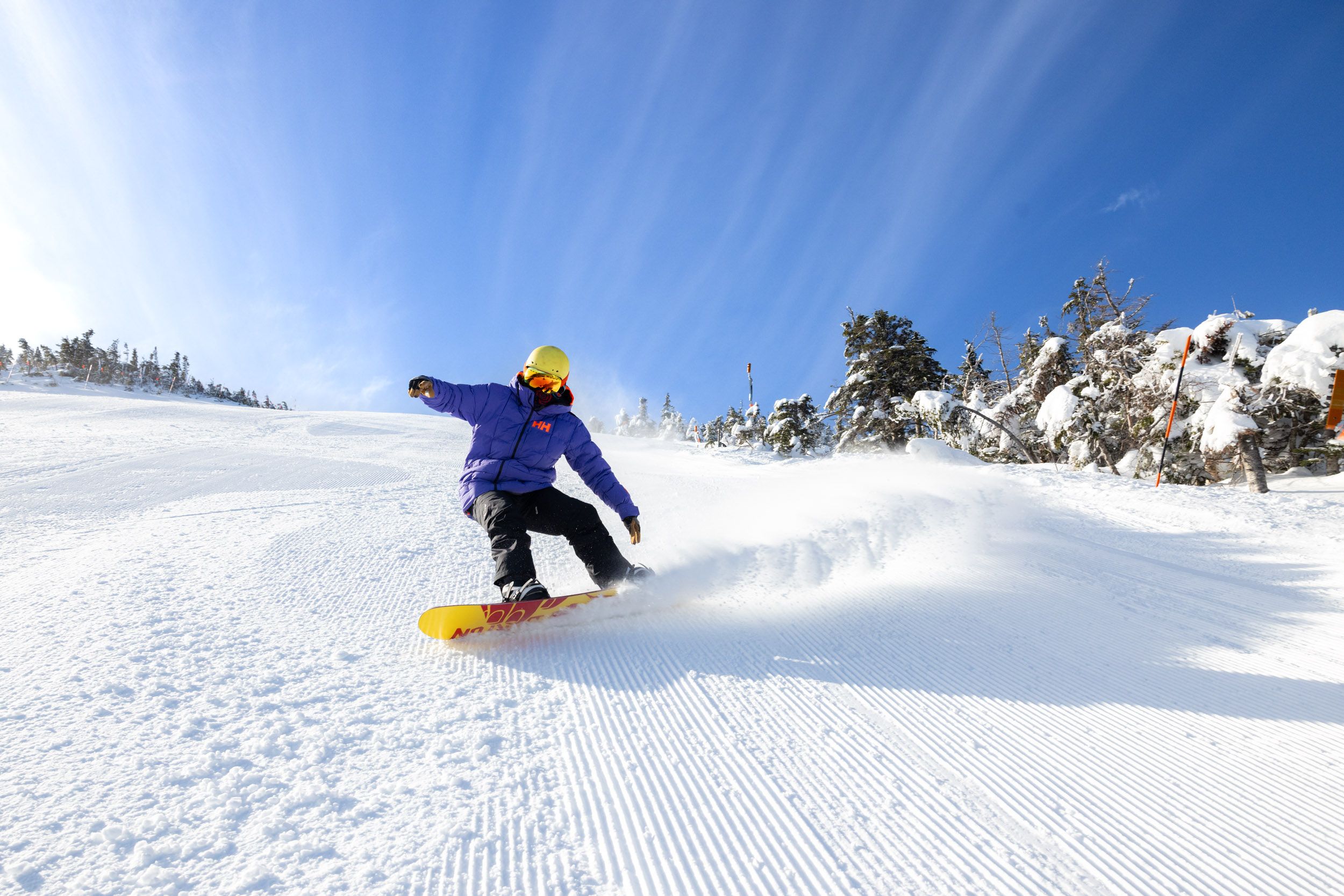 Snowboarder on groomed trail