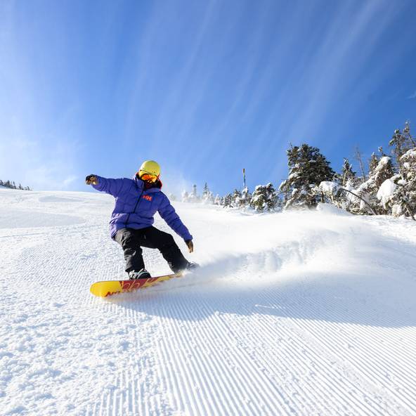Snowboarder on groomed trail