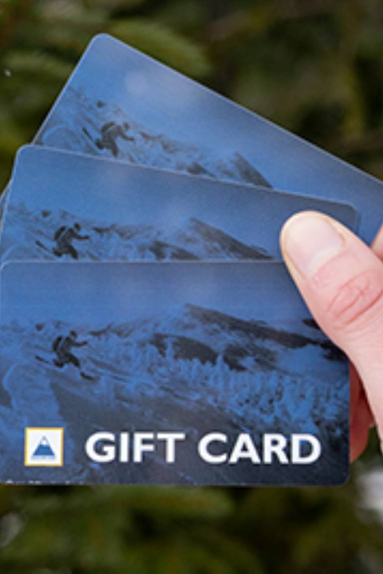 A well-moisturized hand fanning out some gift cards