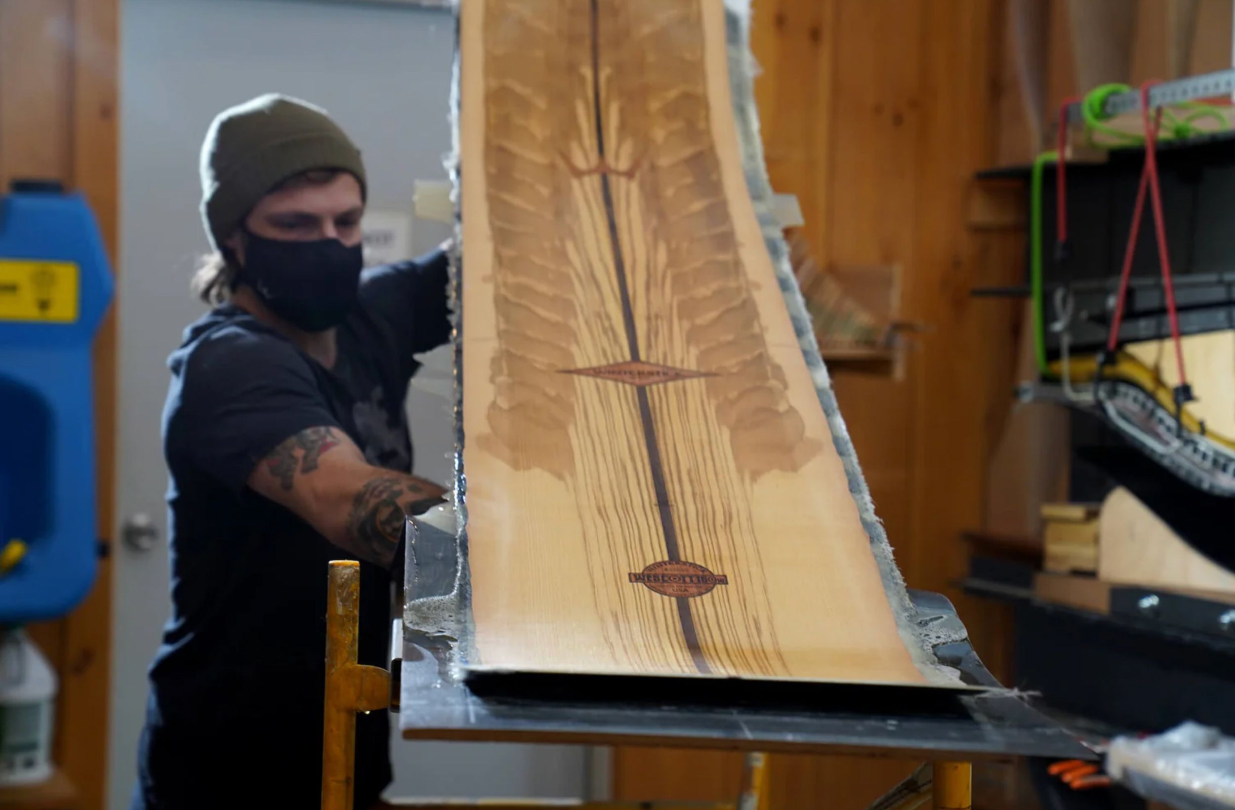 A craftsman makes a snowboard at the Winterstick Factory 