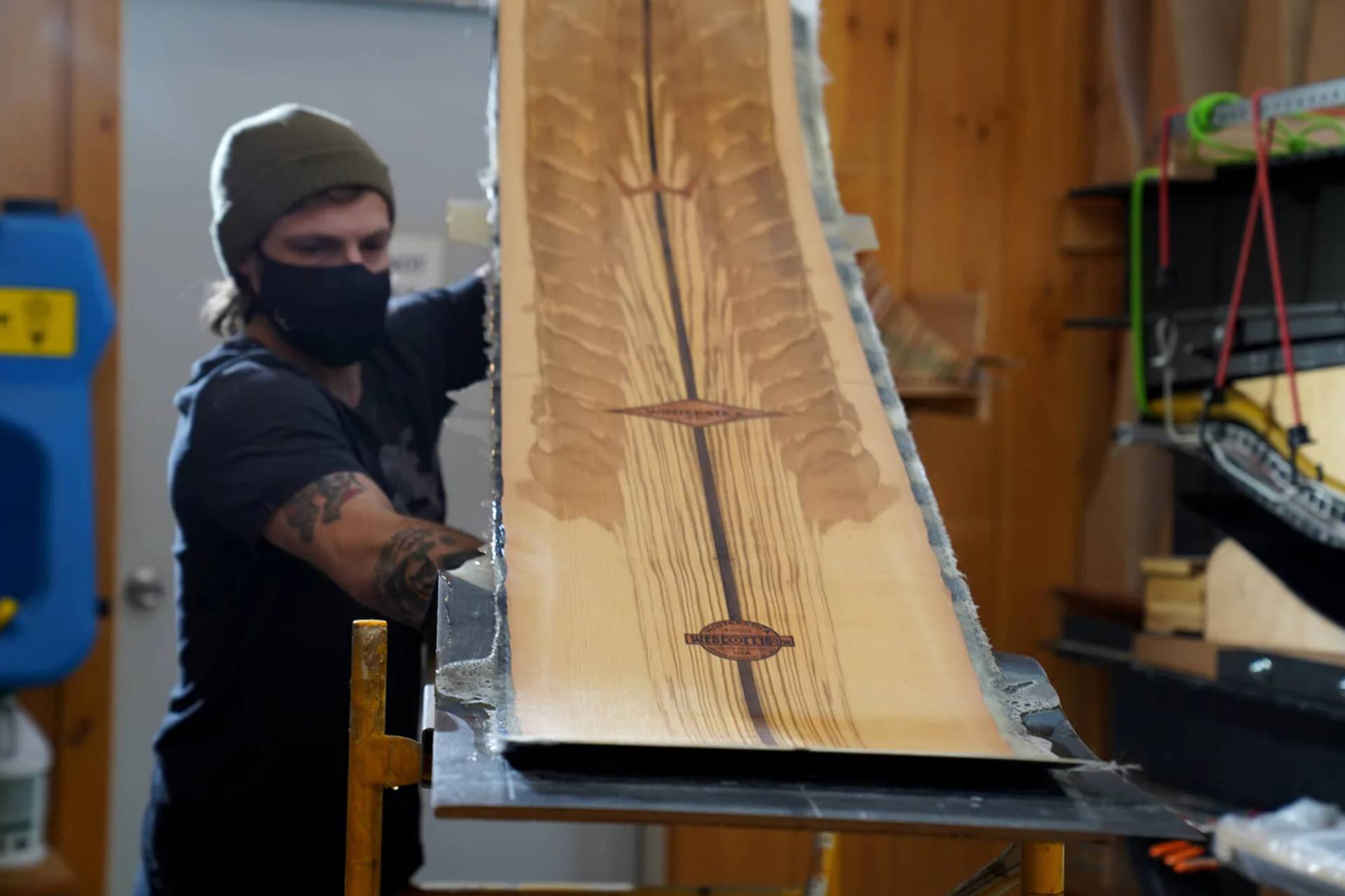 A craftsman makes a snowboard at the Winterstick Factory