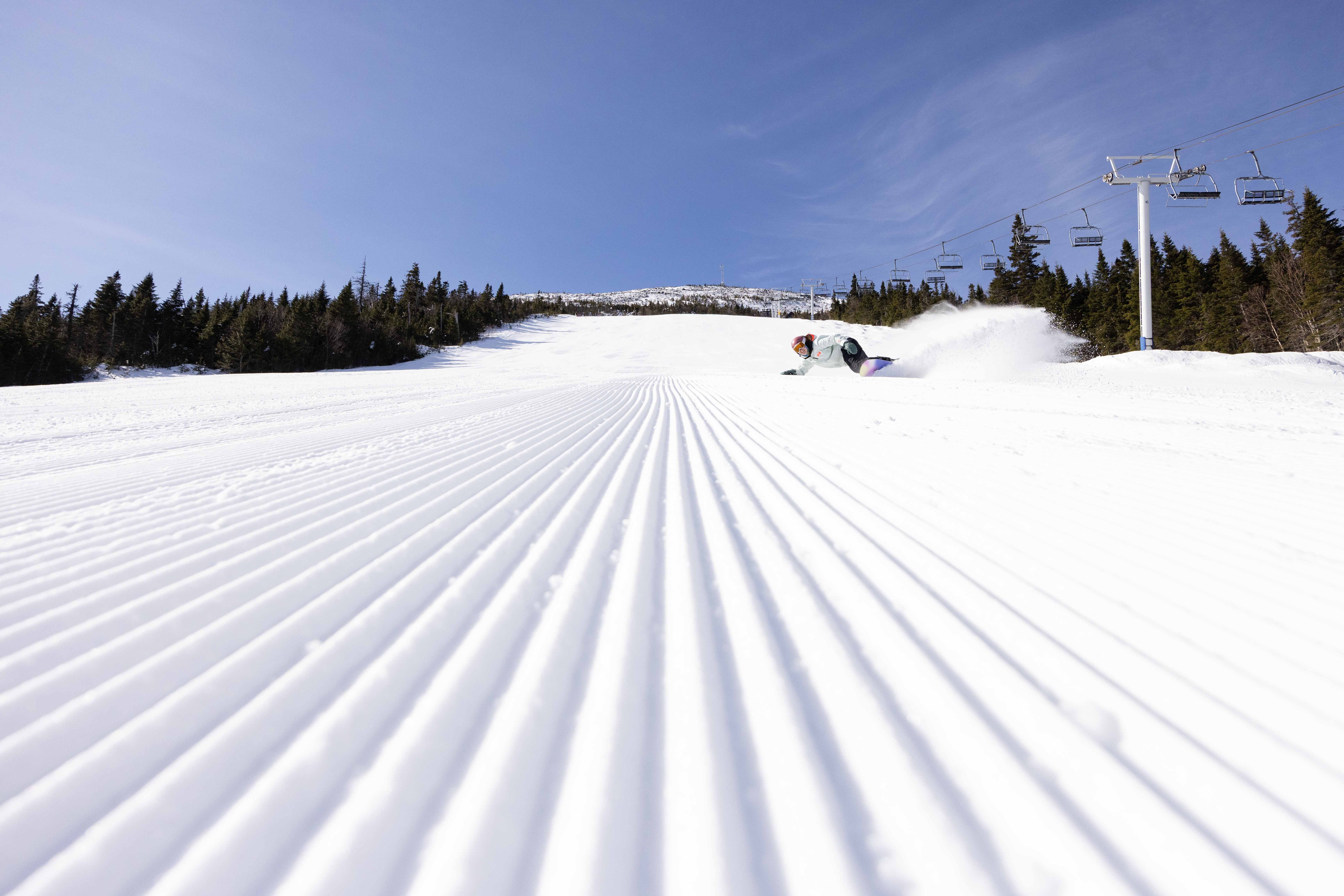 Perfect snowboarder rips down perfect corduroy