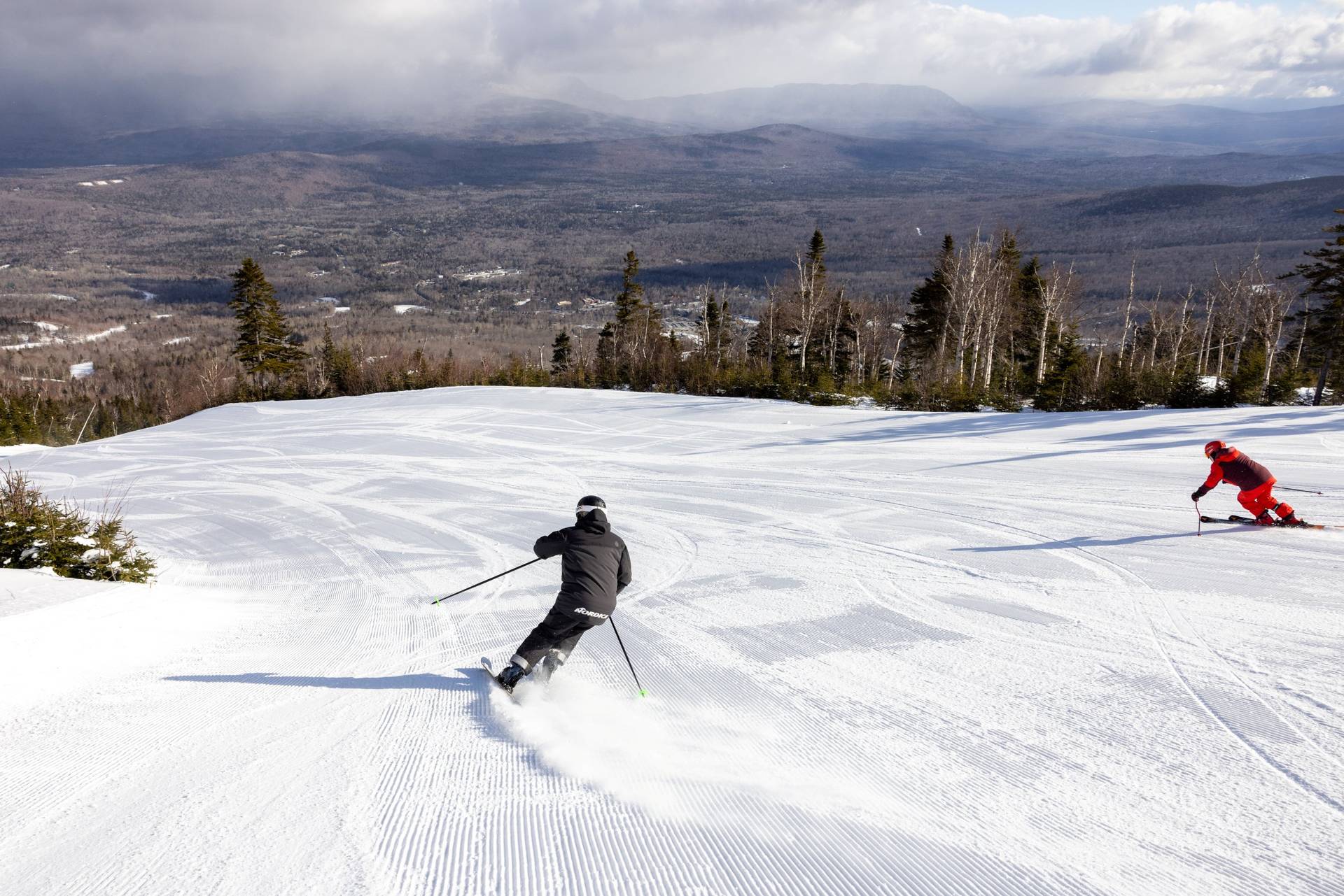 Man in orange jacket skiing