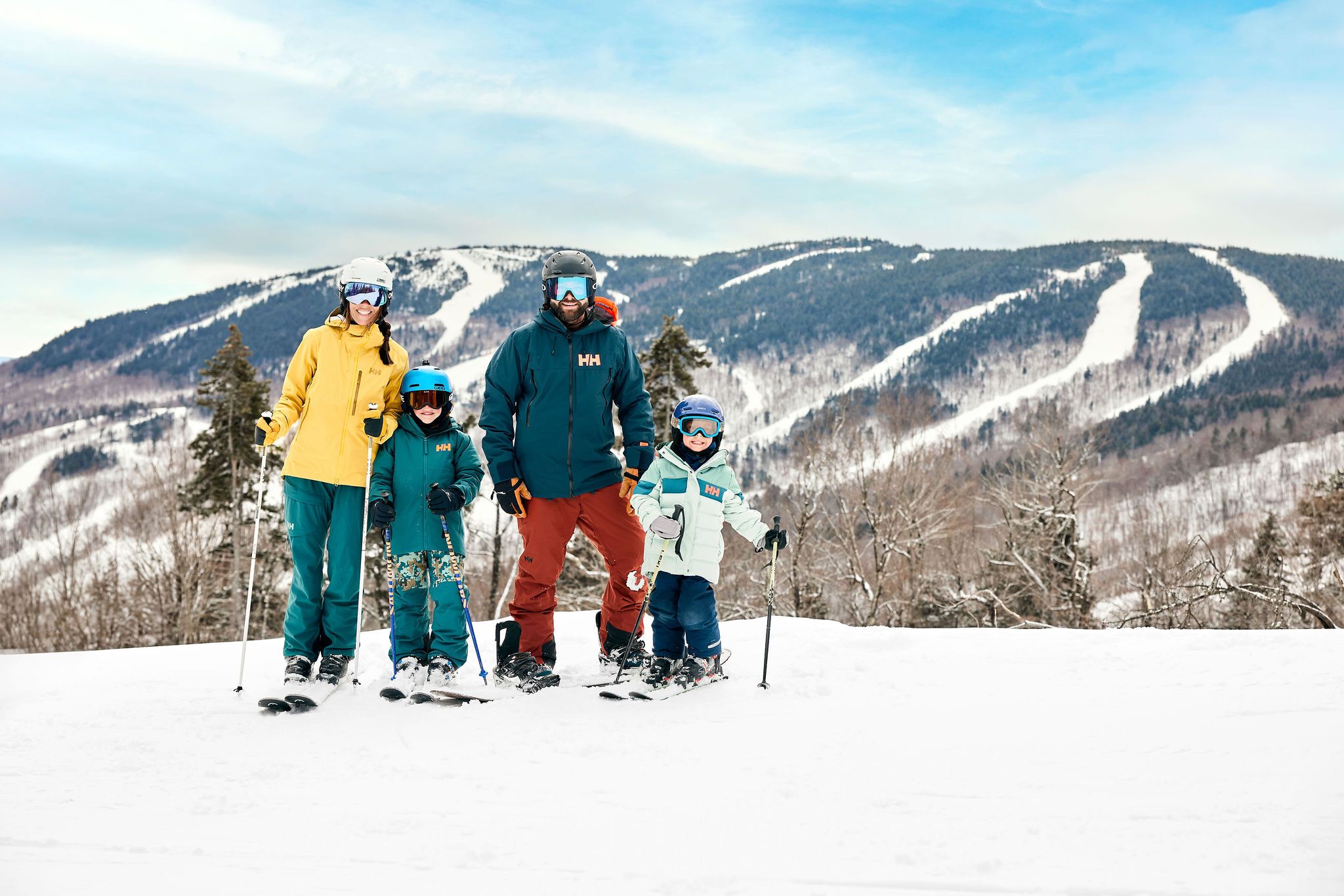 A family posing for a photo on skis at Sunday River.