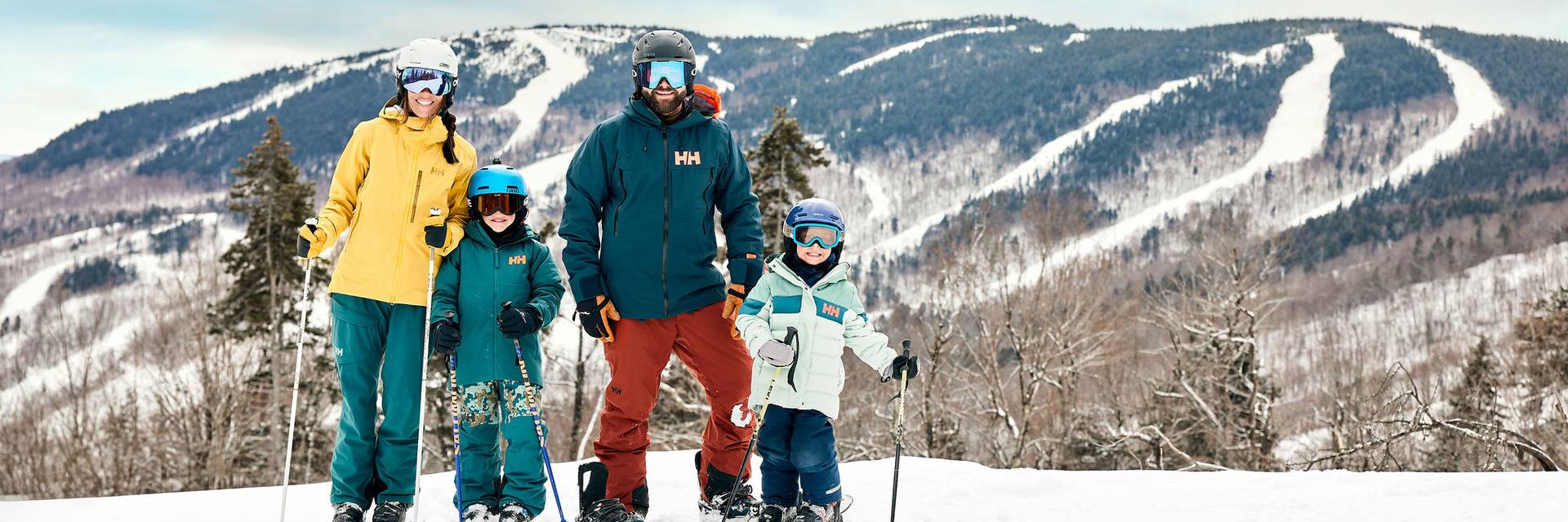A family posing for a photo on skis at Sunday River.