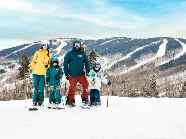 A family posing for a photo on skis at Sunday River.
