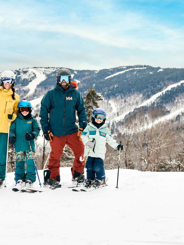 A family posing for a photo on skis at Sunday River.
