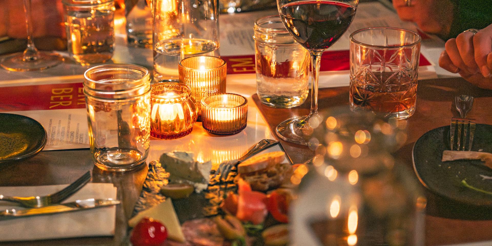 Ember dining with candles and wine at Sunday River.