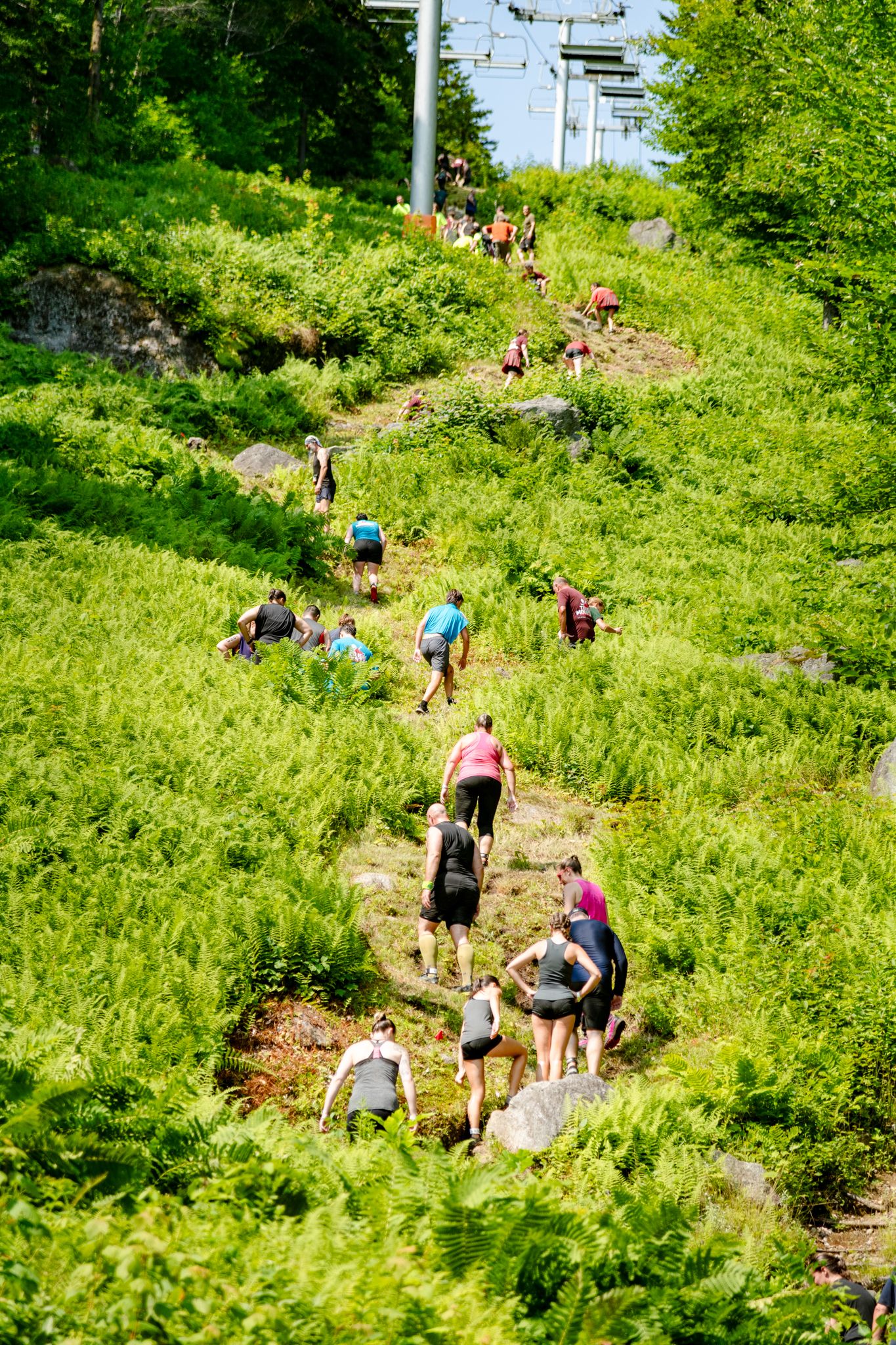 People walking up a giant hill at Tough Mountain Challenge.