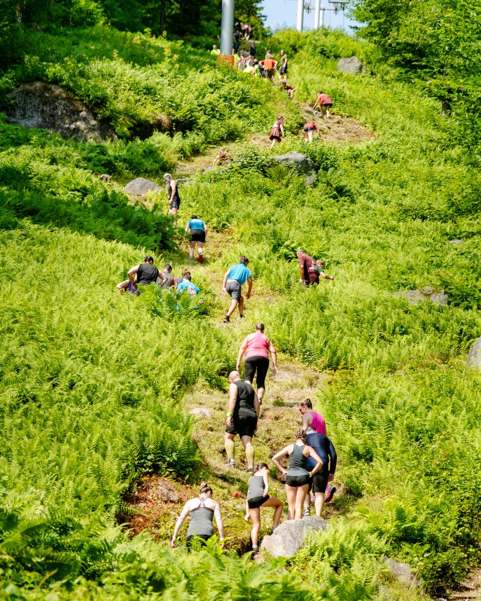 People walking up a giant hill at Tough Mountain Challenge.
