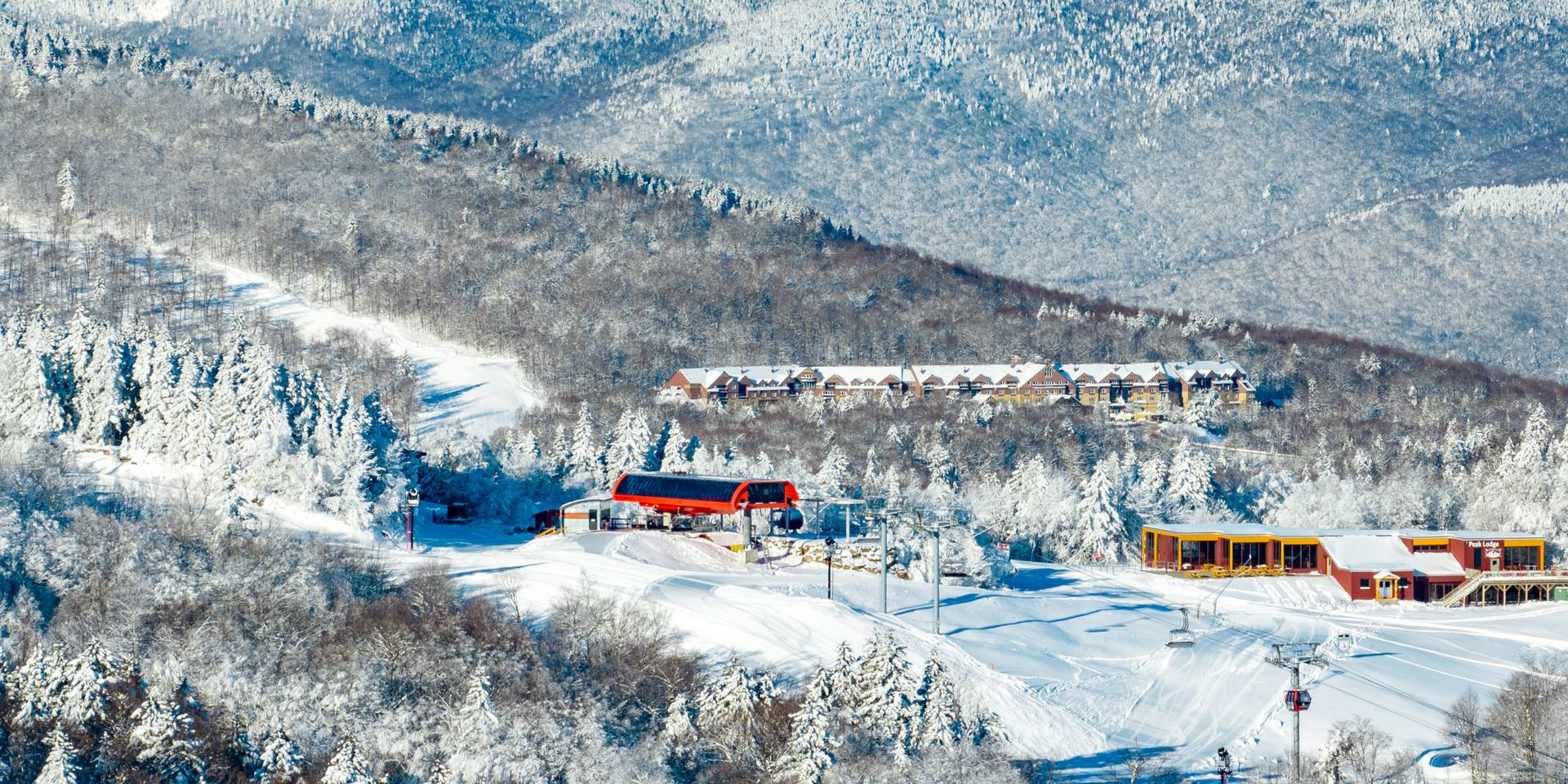 The Jordan Hotel in snow with Chairlift at Sunday River, Maine