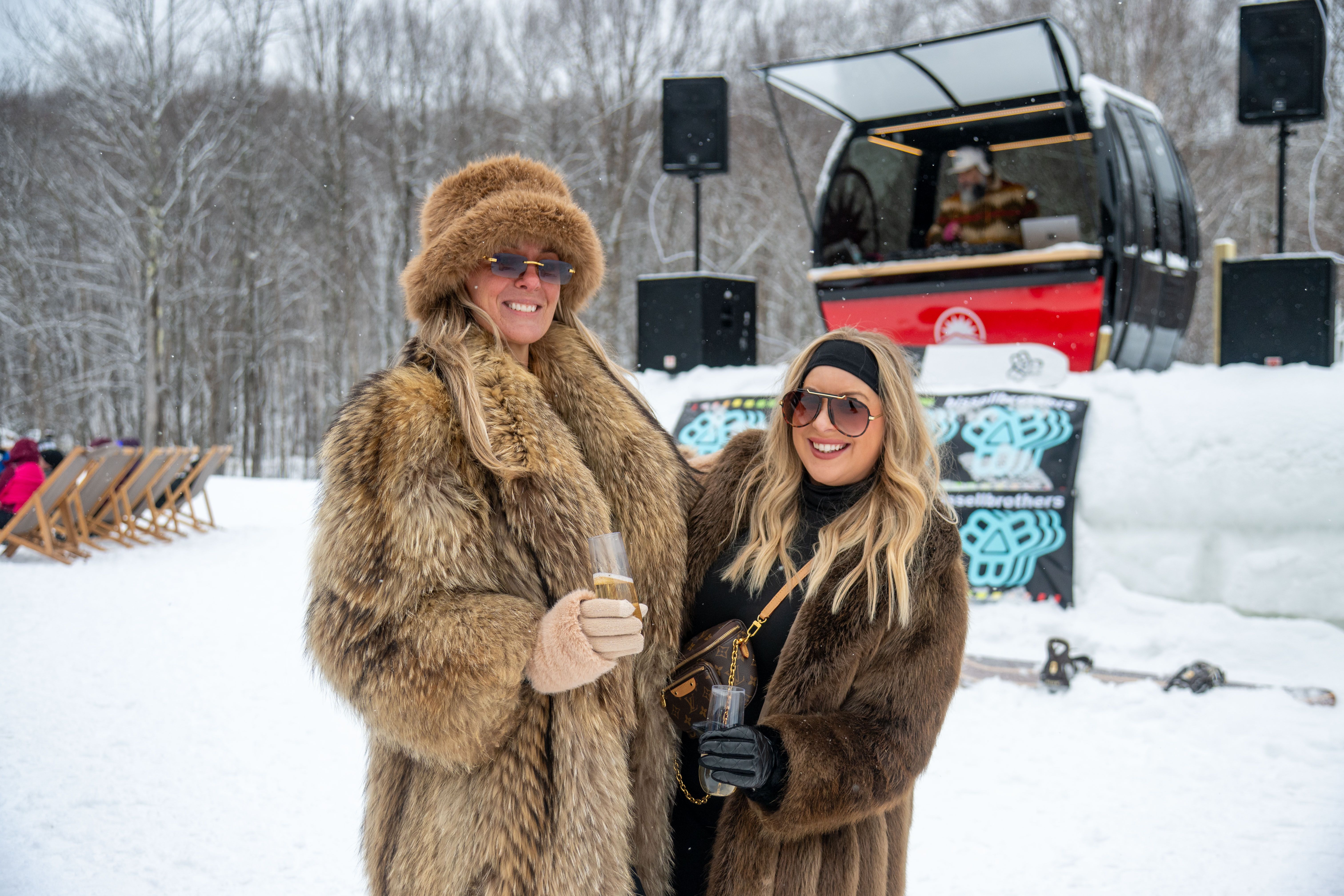 Women in fur coats at the iglu DJ stand.