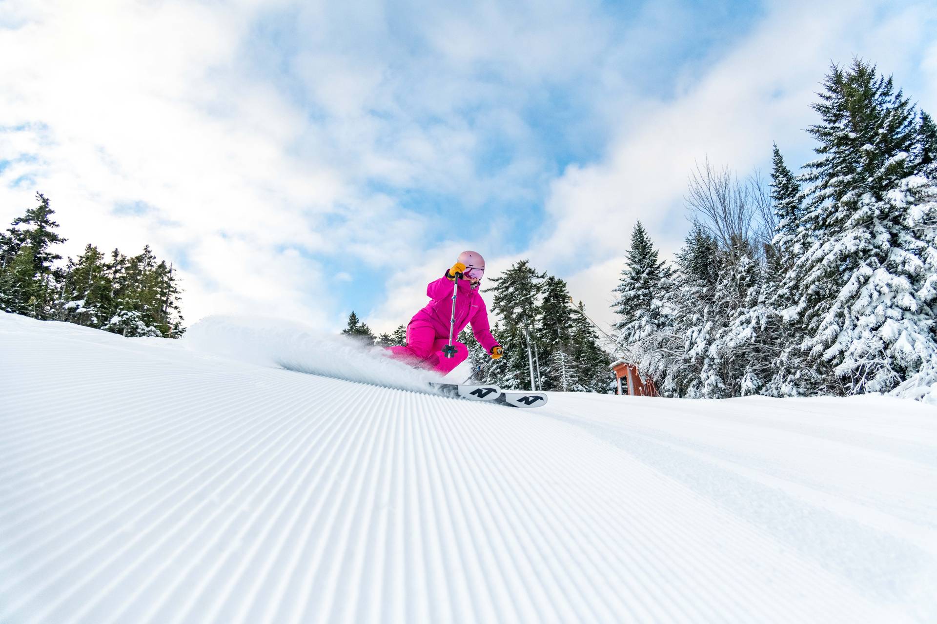 A woman skiing down a trail at Sunday River.