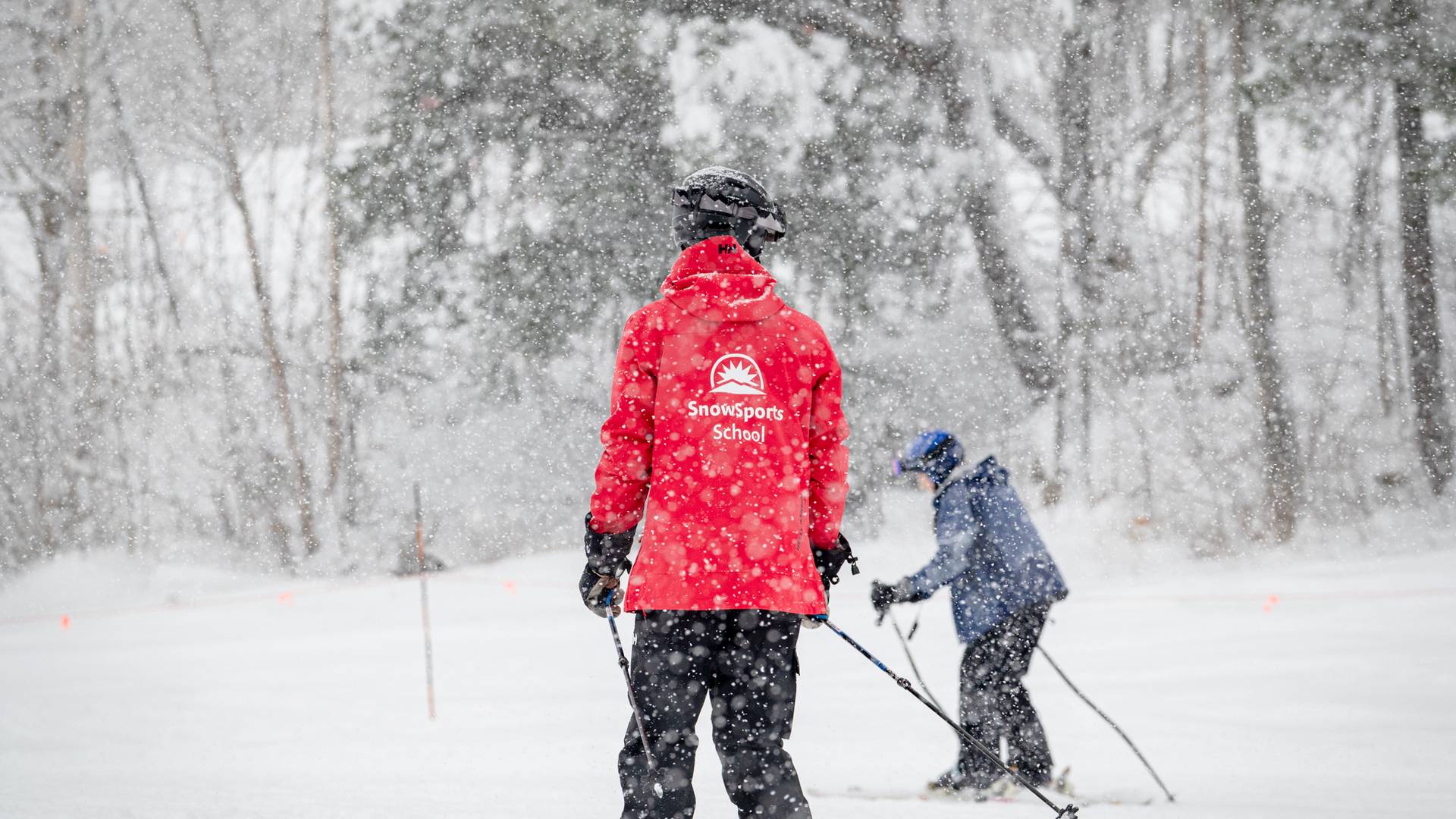 A ski instructor with an adult guest at Sunday River, Maine