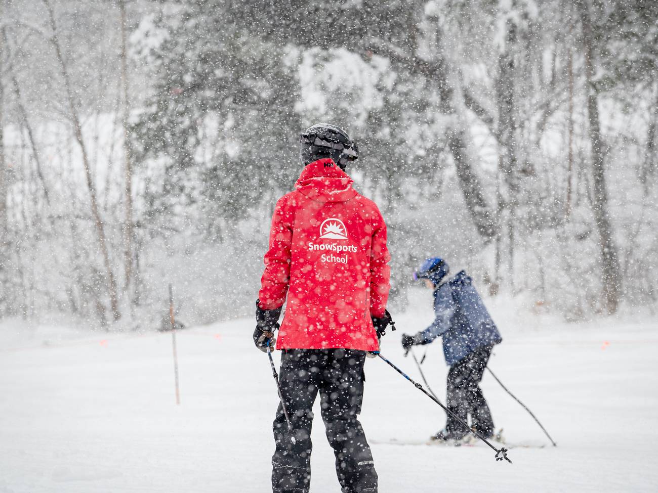 A ski instructor with an adult guest at Sunday River, Maine