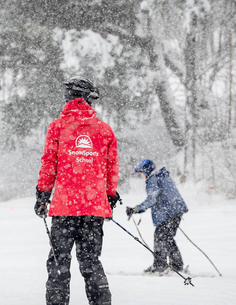 An adult taking a lesson during a snow storm at Sunday River.