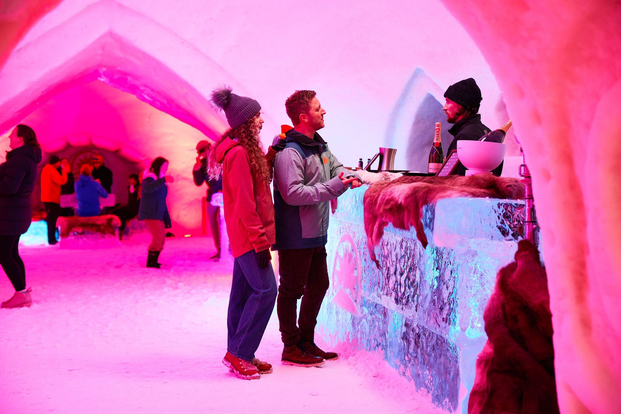 Two people standing at the bar at The Igloo at Sunday River.
