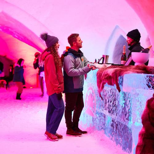 Two people standing at the bar at The Igloo at Sunday River.