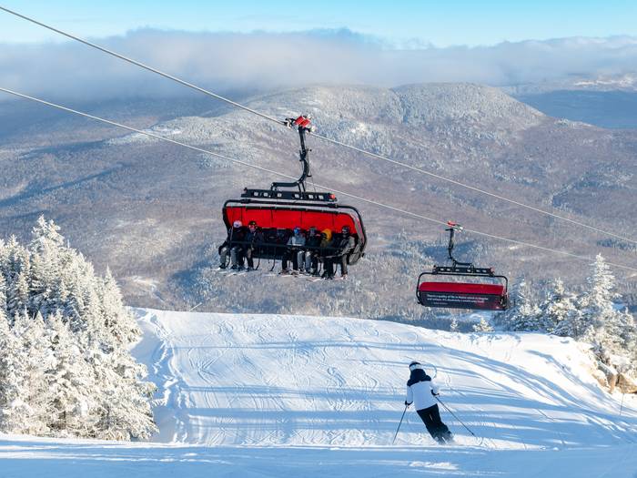 Skiers going down a trial with the Jordan 8 chairs over them at Sunday River.